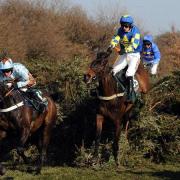 FENCING CLEVER:  Auroras Encore, right, ridden by Ryan Mania, en route to winning the 2013 John Smith’s Grand National
