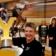 Heather Kennedy, of Wigan Leisure Culture Trust, holds the Tour de Yorkshire trophy watched by Rose Norris, left, executive director of Selby District council, and Mary Weastell, chief executive of the council