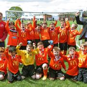 McDonald’s franchisee John Atherton presents a new kit to Poppleton Under-9s               Picture: Richard Doughty