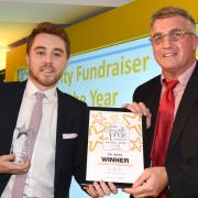 Ian Jones, left, receives his Charity Fundraiser of the Year award from Ian Pryer, of sponsors Pryers