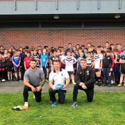 Front, Adam Prentis from the Knights Foundation is flanked by Castleford Tigers stars and former Knights Scholarship graduates Alex Foster, left, and Greg Minikin, pictured along with youngsters and coaches at the launch of the club's new Excel
