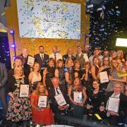WINNING SMILES: All the winners of the 2018 York Community Pride Awards celebrate on stage at the end of the ceremony at York Racecourse, above. The awards were hosted by ITV television presenter Kate Walby, below