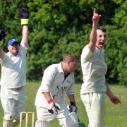 DUNN AND DUSTED: Hirst Courtney’s Sam Dunn, pictured in the foreground, claimed bowling figures of 97-4 and then hit 48 to clinch a convincing HPH York Vale League division two victory over Hemingbrough