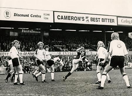 10/04/76 - York City 3, Plymouth 1: Brian Pollard shoots York City into the lead through a ruck of Plymouth defenders.
