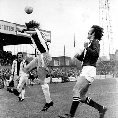 17/1/76 - York City 0, West Brom 1: West Brom defender Alistair Brown heads away with City's Chris Topping closing in during the game at Bootham Crescent.