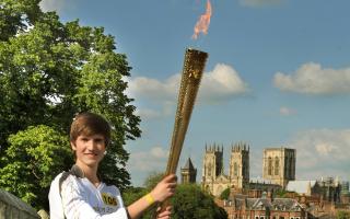 Flashback to summer 2012 - Sixteen year old Scott Stockdale posing with the Olympic Torch on the bar walls. Picture: Nigel Holland.