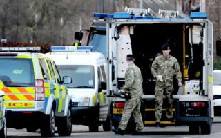 The forces assess the scene on a hand held device on Hull Road following the discovery of a bomb