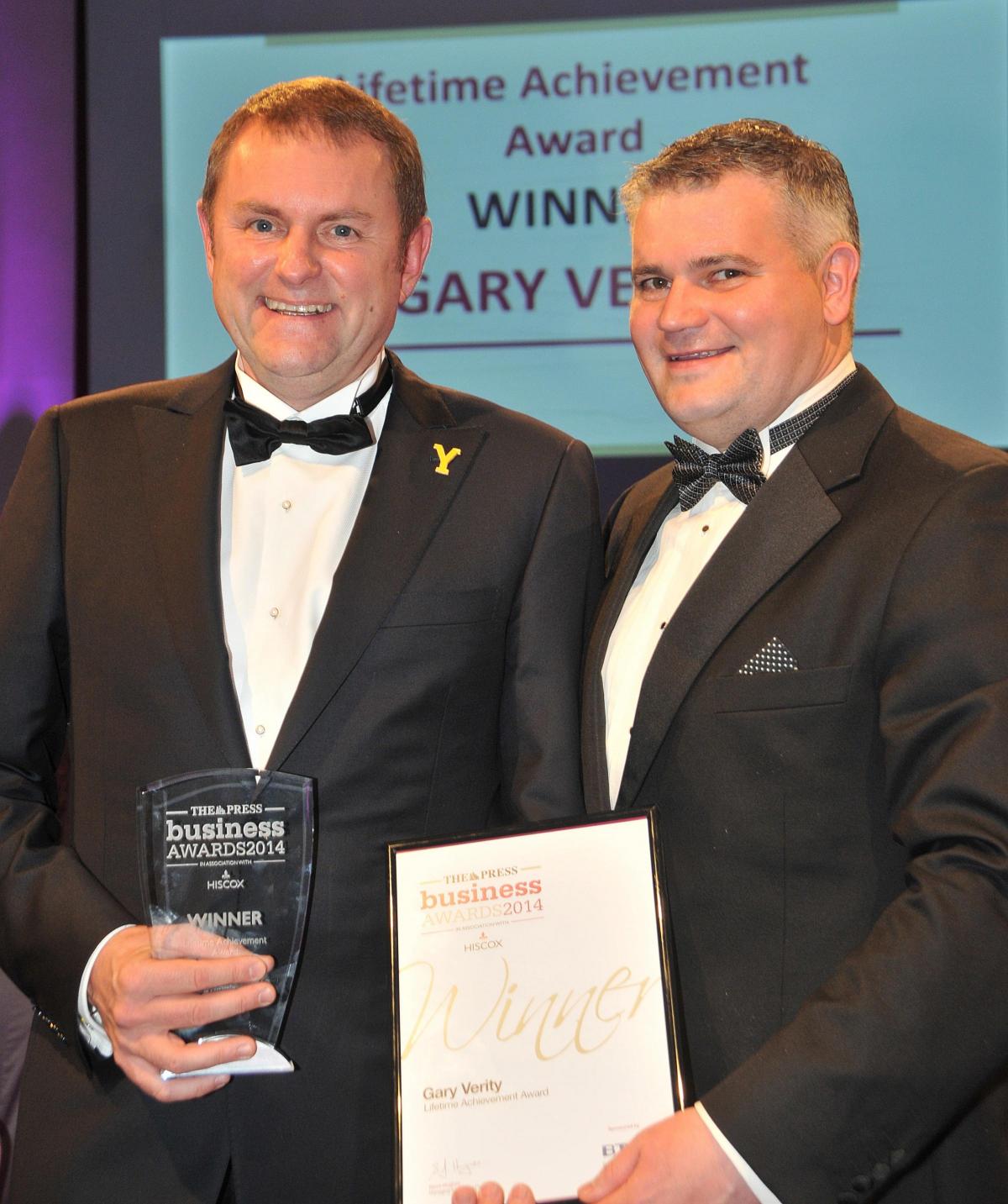 Gary Verity, chief executive of Welcome To Yorkshire, left, receives his Lifetime Achievement Award from Danny Longbottom, managing director of BT Business