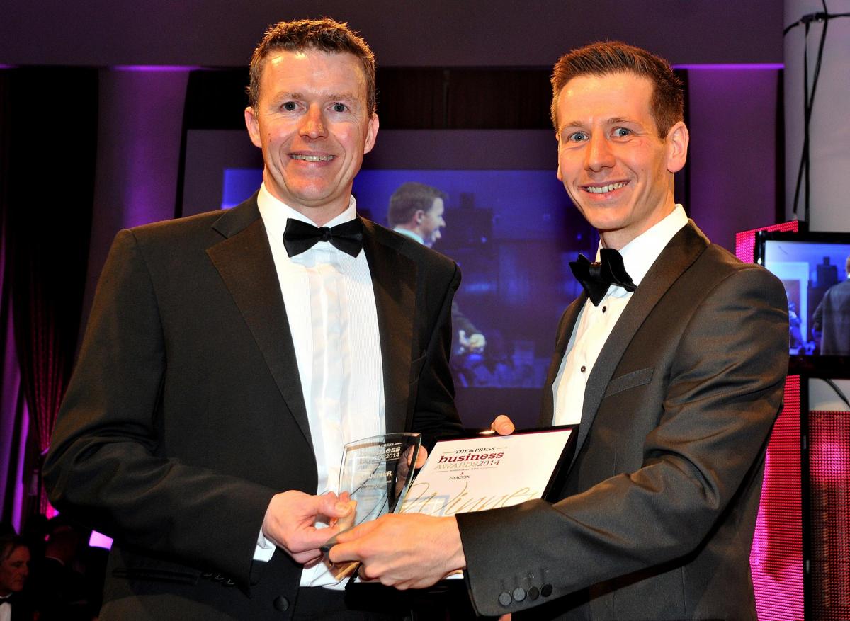 Robert Burns of 9xb, left, receives the Technology Business of the Year award from Stephen Ridley of sponsor Hiscox UK at The Press Business Awards at York Racecourse