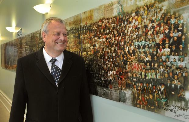 Professor David Fleming, the Vice Chancellor of York St John University, with the  Alumni Abudantes panels created by local artist Catherine Scriven. The latest panel has been recently put up on a adjacent wall.