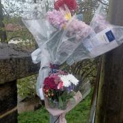 Floral tributes have been left