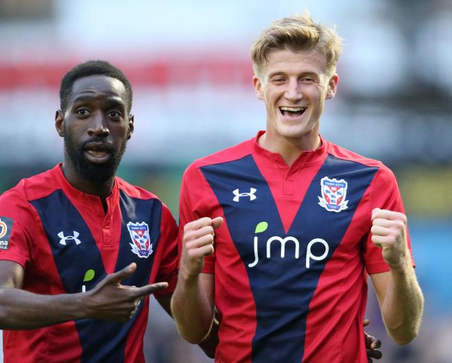 York City pair Adriano Moke (left) and Alex Kempster (right) celebrate a goal against Stockport County. Picture: Gordon Clayton