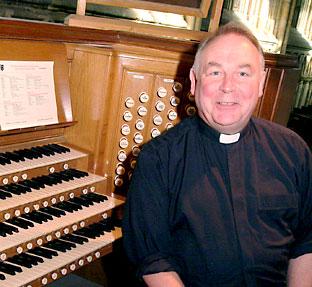 Father Keith Richards, the Vicar of Selby Abbey, with the existing Abbey organ