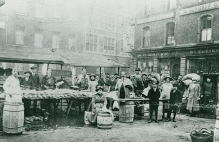 From around 1920 it is beleived this was a fish stall in St Sampson's Square.  The sign outside W. P. Brown's was advertising a sale.