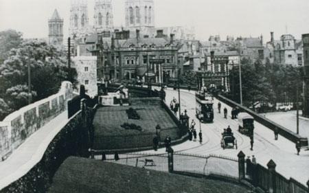 The classic view of The Minster.  Note the open top tram, and the horse drawn carriage proceeding towards Lendal Bridge.