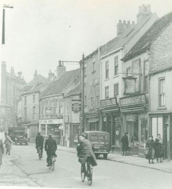 Walmgate in the 1930s. The shop in the middle is Cussins & Lights Ltd, the van is Carter & Son Ltd, Butchers, Shambles, and Jackson's joiners and undertakers stood next to the Red Lion Hotel.