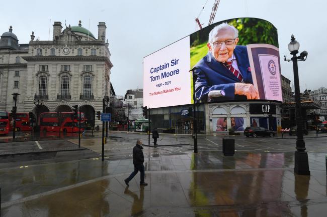 A tribute to Captain Sir Tom Moore is broadcast on the Piccadilly Circus lights in central London. The 100-year-old charity fundraiser died on Tuesday after testing positive for Covid-19. Picture: PA