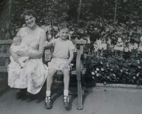 Lynne with her mum in 1960 with baby sister Yvonne - Lynne holding her sticklebacks caught in the lake at Rowntree Park