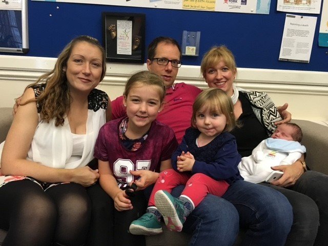 Gemma with the first family she helped, clockwise from left, Gemma and daughter Abby with Doug and Carri, and surrogate children baby Jaime and Lydia