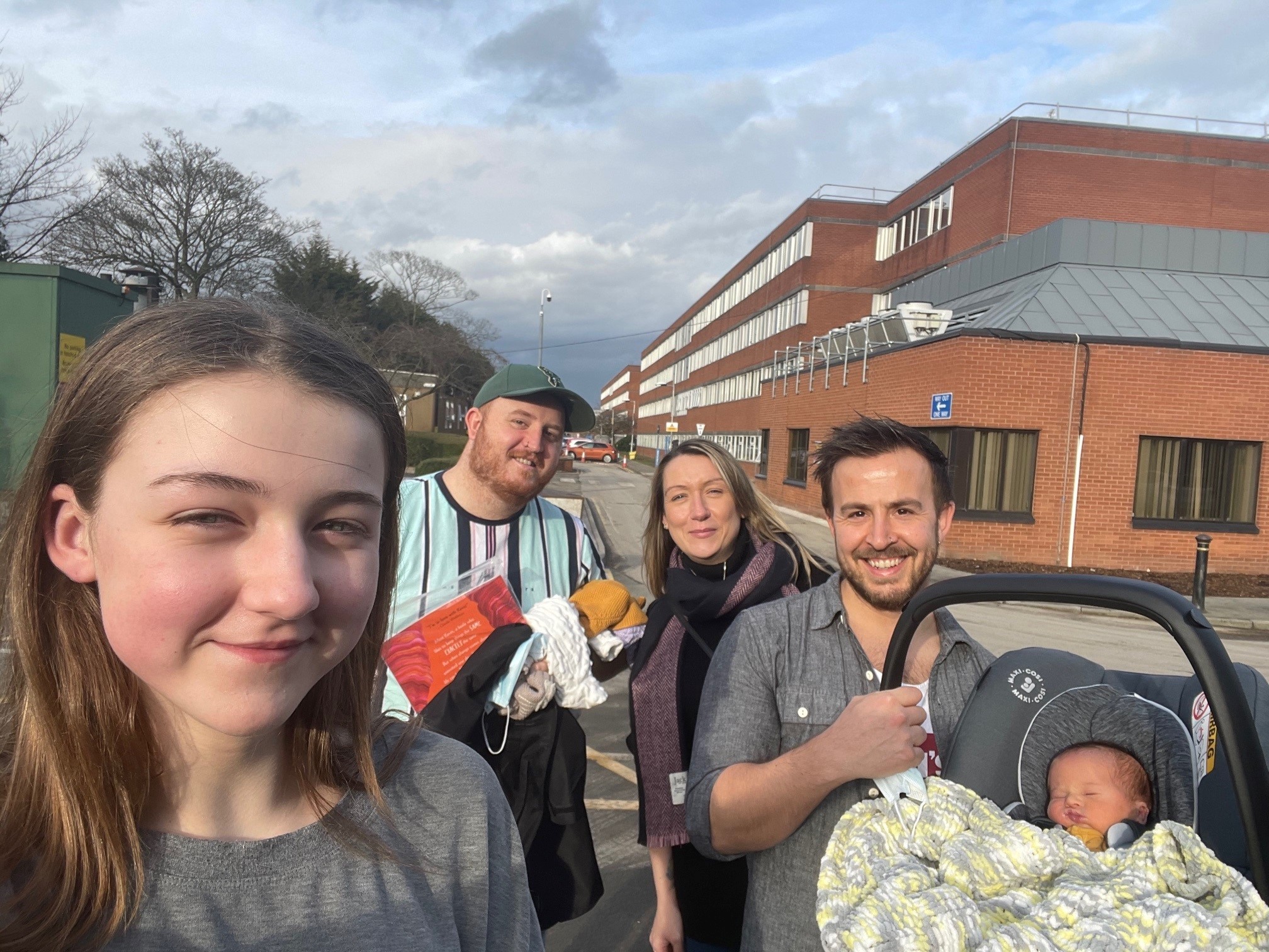 Gemma, back right, leaves York Hospital in February after giving birth to fourth surrogate child Orson, with her daughter Abby and parents Karl and Nick