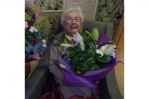 One of the Boroughbridge Manor care home residents shows her delight after flowers were given to the home by Morrison's supermarket
