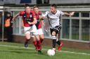 Hereford’s Jordan Nicholson gets away from York City’s Josh King and Kallum Griffiths. Picture: Steve Niblett/Hereford FC