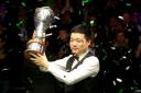 Ding Junhui celebrates with the trophy after winning the Betway UK Snooker Championship at York Barbican. Picture: Richard Sellers/PA Wire