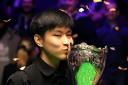 Zhao Xintong kisses the trophy after winning the Cazoo UK Snooker Championship at the York Barbican. Picture: Richard Sellers/PA Wire