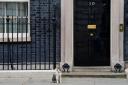 Larry the cat sits outside 10 Downing Street, Westminster, London. Credit: PA