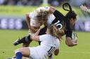 England's Zoe Aldcroft (top) and Zoe Harrison (bottom) tackle New Zealand's Ruahei Demant during the Women's Rugby World Cup final match at Eden Park in Auckland, New Zealand.