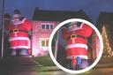 Peter's giant Santa outside his Poppleton home, and in comparison to his sons Luke, 8, and Will, 11