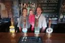 A happy family behind the bar