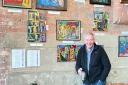 Ron Bould, 69, in front of his exhibit at Cityscreen