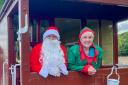 Father Christmas and an Elf on board the brake van at the YWR