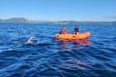 Tim Wilson on his marathon swim, with the crew of his support dinghy