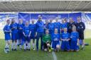 Woldgate College’s Under-15 footballers with England star Andros Townsend after their 3-2 defeat by Didcot Girls’ School in the final of the English Schools’ FA PlayStation U15 Schools’ Cup for Girls at the Madejski Stadium