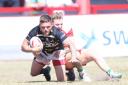 York City Knights' Ben Cockayne is hauled down at Keighley Cougars. Picture: Gordon Clayton