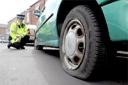 PCSO Tim Barrett with one of the cars that had its tyres slashed in the Burton Stone Lane area of York