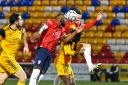 York City's Lenell John-Lewis (left) and Jack McKay (right) battle for a cross into the box. Picture: Tom Poole