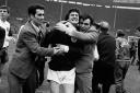 Library file dated 16/04/1967 of Scottish footballer Jim Baxter, enthusiastically being hugged by fans after Scotland beat England 3-2 at Wembley. The Scotland and Glasgow Rangers hero,  died from cancer at the age of 61, Saturday 14 April, 2001. See PA