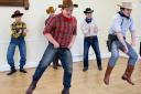 Steven Jobson and Martin Lay, front, lead the leaping in rehearsal for the Bev Jones Music Company's Oklahoma!