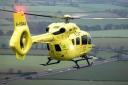 An eyewitness reported an air ambulance had landed in a field near the road