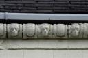 The mysterious stone faces on the gutters on the shop on the opposite corner of the road to Christine Waddington’s York Post Office in the 1990s