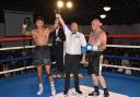 Boxing prospect Michael Fafera (left) has his hand raised after his win over Darryl Sharp (right). Picture: Julian Hudson