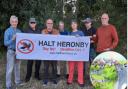 Members of the Halt Heronby campaign group protest against the plans for (artist's impression inset) a new settlement near Escrick, south of York