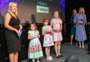 Sarah Bennett from Visavvi presenting the Child of the Year award to Erica Reynolds, Billie Grace Bowater and Scarlett Walker