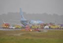 Heavy winds forced a passenger plane to skid off a runway on Friday