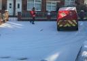 A postie doing his round in a street near Cemetery Road in York