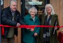 Joan New cuts the ribbon with Denise Howard and John Corden
