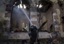 Firefighters put out the fire a railway station after Russians hit in Kostiantynivka, Donetsk region, Ukraine, Sunday, Feb. 25, 2024. A woman was wounded and a railway station, shops and residential houses were badly damaged amid heavy bombing